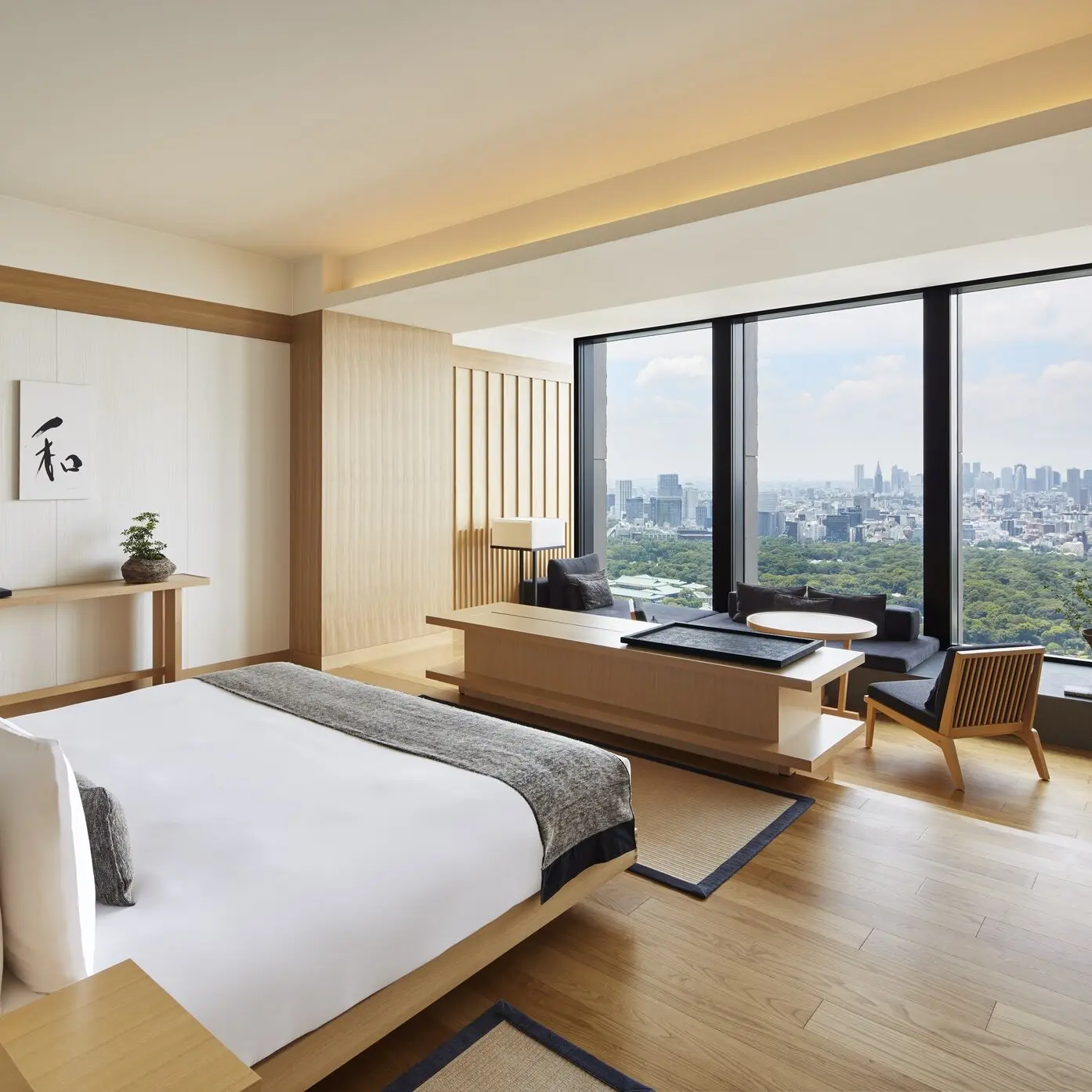 Aman Tokyo deluxe suite with floor-to-ceiling windows and city views